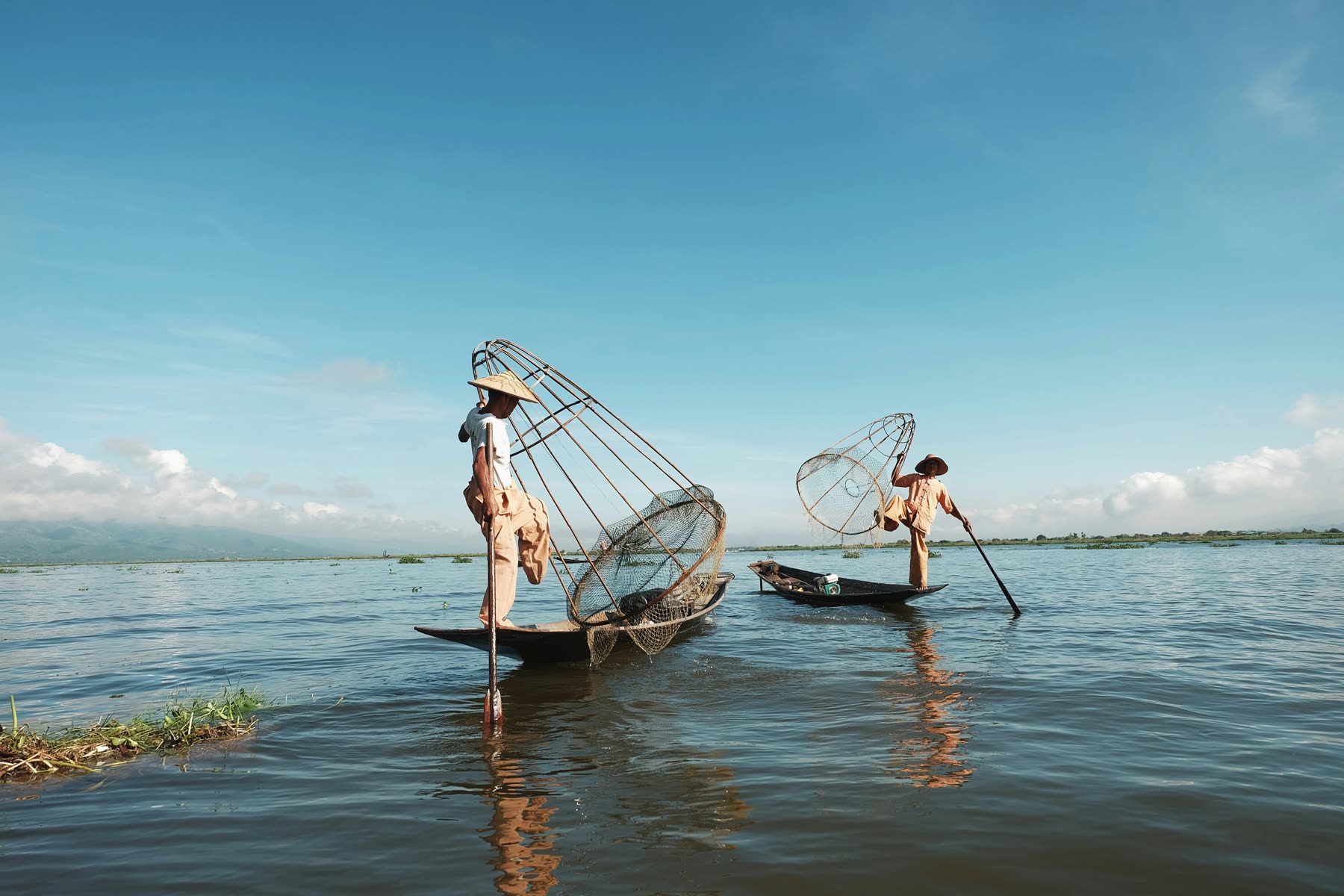 Fishermen casting nets at sunrise — blue economy
